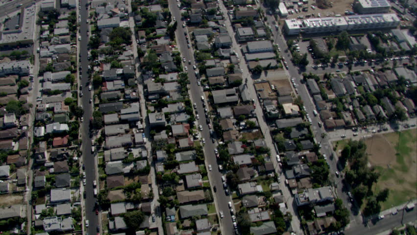 Fly over of homes in a residential area inside the city in Southern California