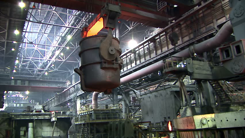 Iron and Steel Works. A huge crane transports the ladle of molten metal.