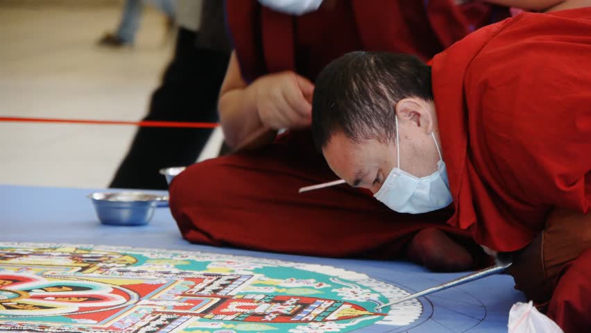 NOVOSIBIRSK - CIRCA APRIL 2012: Tibetan monks making sand mandala circa April 2012 in Novosibirsk, Russia.