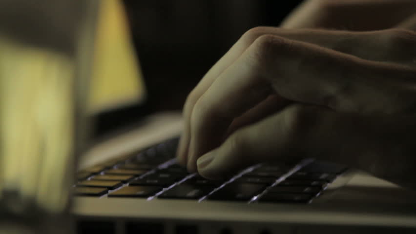 Close up of hands typing on a computer keyboard
