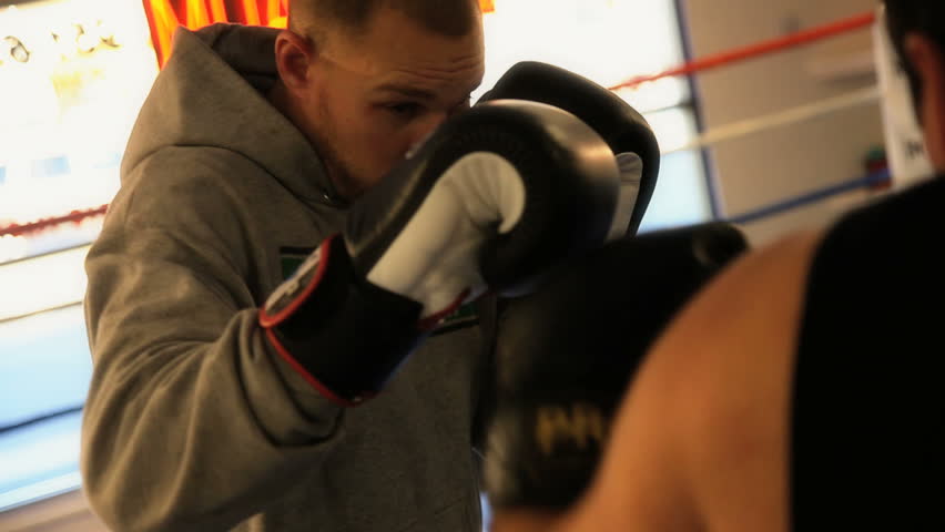 two men sparring in the boxing ring