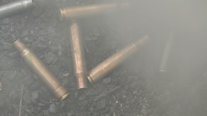 spent ammunition cartridges falling from a rifle