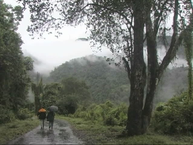 A rainy day in Arunachal Pradesh, India.  Couple walking on a rough road in the Himalayas mountain.