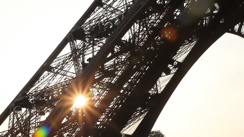 Eiffel Tower Sunset. Wide. Timelapse.
Leg of Eiffel Tower at sunset with tourists walking up. Timelapse shot. Paris, France. 
