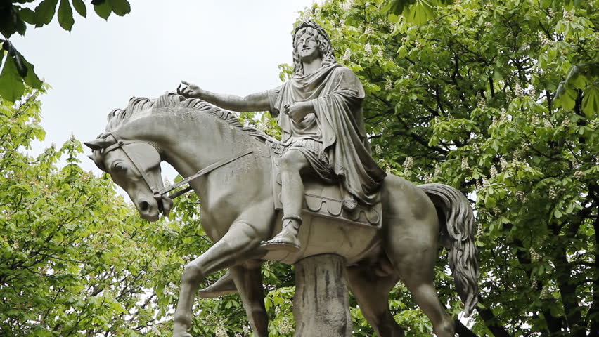 Marble equestrian statue of King Louis XIII at Place des Vosges. Springtime in Paris, France.