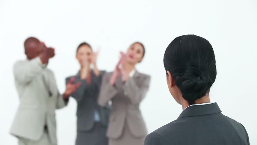 Businesswoman being congratulated by her co-workers against white background
