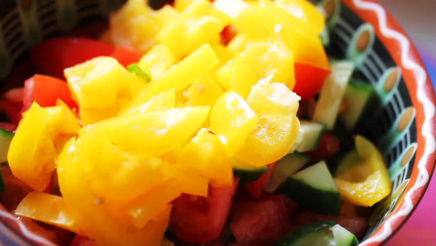 process of preparing salad of cucumbers, tomatoes and peppers