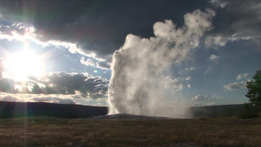 Very wide view of a Geyser spewing in Yellowstone National Park in Wyoming