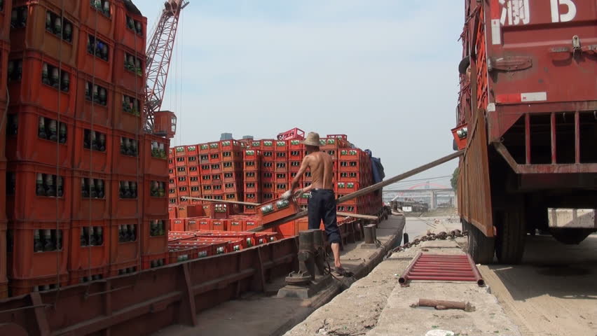 CHONGQING - AUGUST 17 2010: Workers are loading a ship with crates of beer in Chongqing, China
