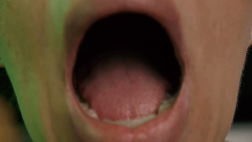 Doctor Checking Throat (HD) routine throat checkup on a woman with irritated tonsils. Take changes into throat with depressed tongue close up. 