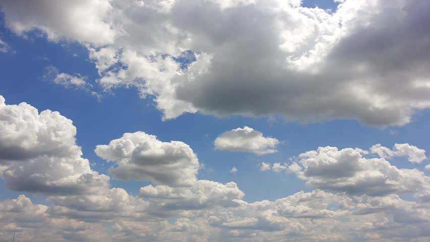 Clouds over blue sky. Time lapse