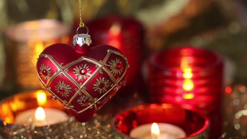 A heart-shaped Christmas tree decoration and tealights
