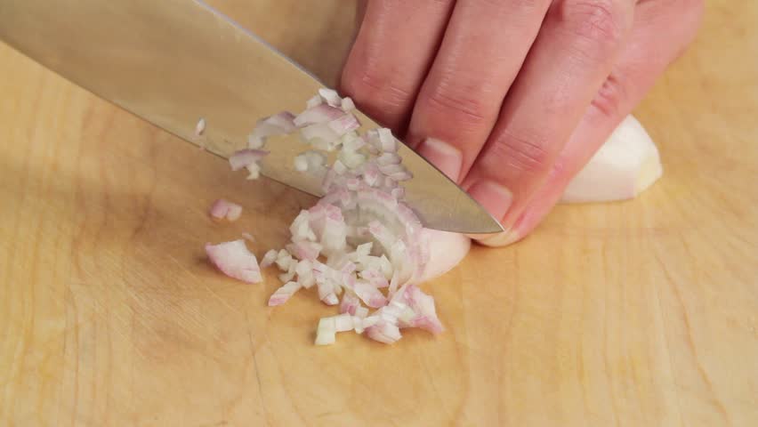 Chopping shallots finely