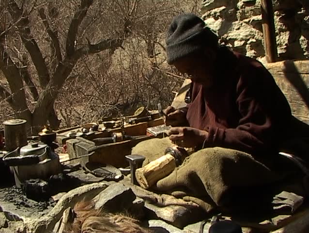 Craftsman engraving sacred symbols on praying wheel (Ladakh, Jammu & Kashmir)