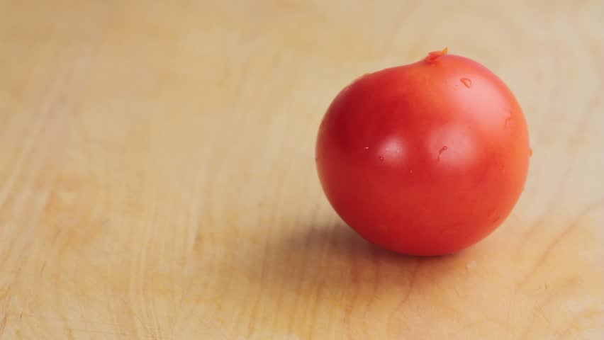 A tomato being quartered