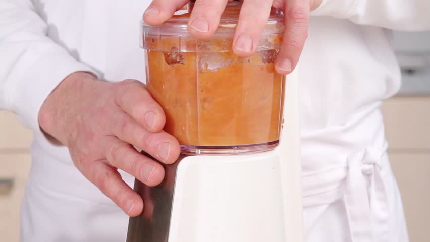 Pureeing vegetables in a blender and adding vegetable stock