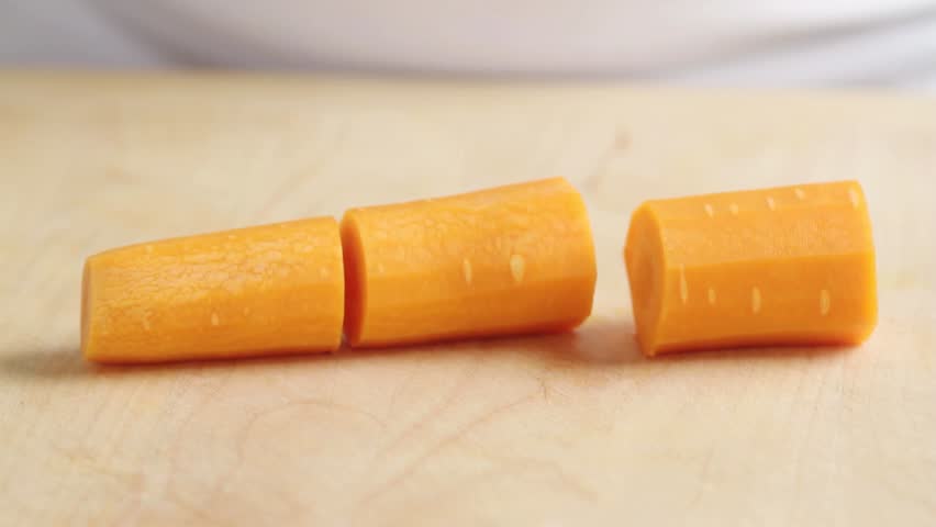 Chopping lengths of carrot into julienne strips