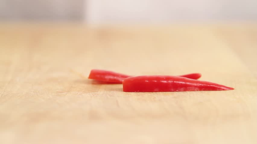 Chilli peppers being cut into fine strips
