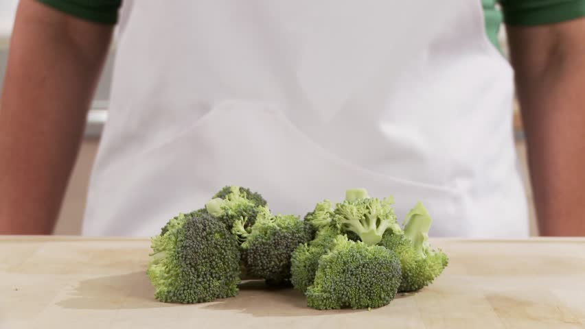 Broccoli being broken into florets