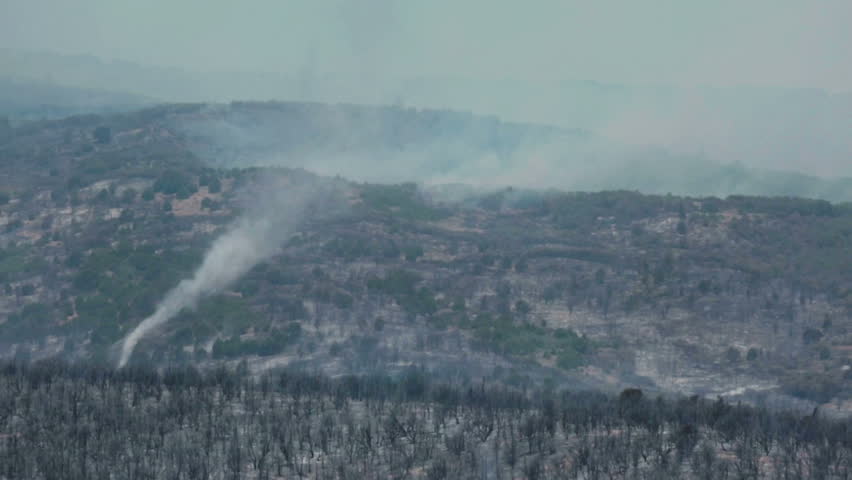 FOUNTAIN GREEN, SANPETE, UTAH 25 JUN 2012: Forest fire tornado twister burn area. Wildfire burns forest mountain violent destruction. Blaze destroyed dozens of homes. Wood Hollow Utah. FEMA