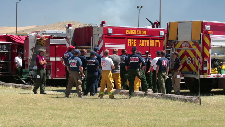 MORONI, SANPETE, UTAH 25 JUN 2012: Firemen with fire trucks and equipment prepare at briefing to fight dangerous out of control wildfire. Wood Hollow Utah. FEMA Federal Government assistance.
