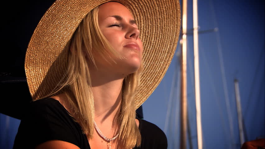 Beautiful blonde girl drinking champagne on a yacht