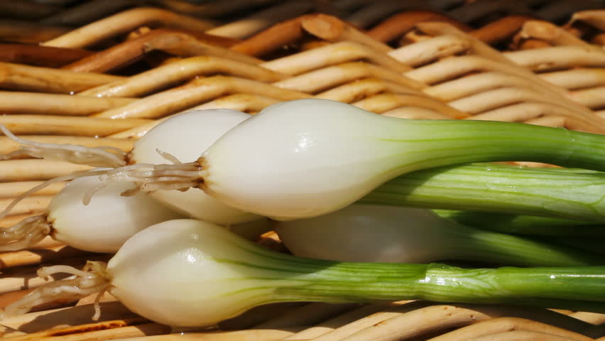 	Green onions in a basket.