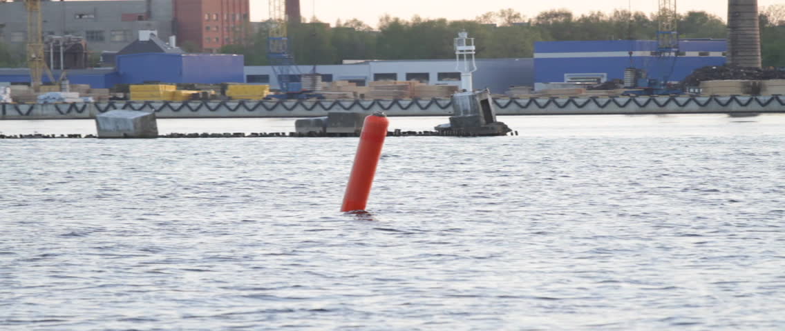 A red buoy, anchored at the Riga Freeport along the Daugava river, in Riga, Latvia.