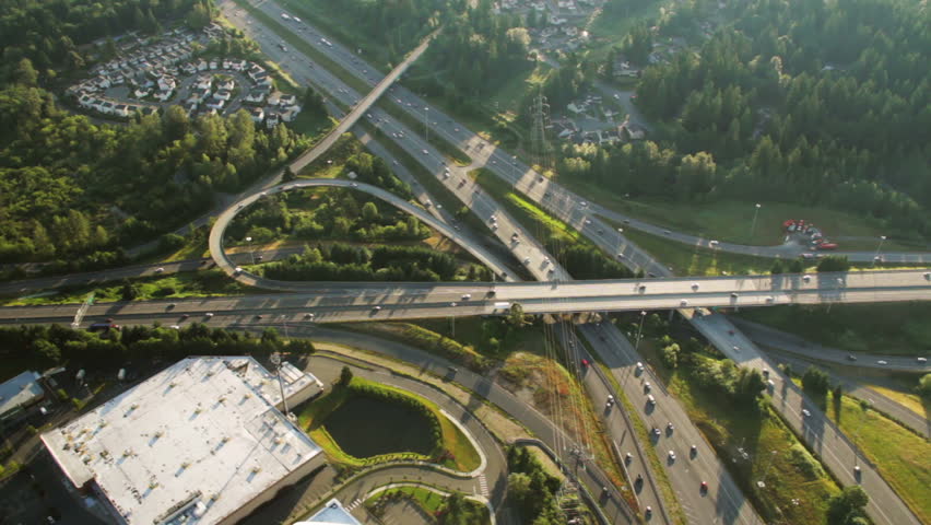 Aerial perspective of interstate commuter traffic at junction on clear, early morning