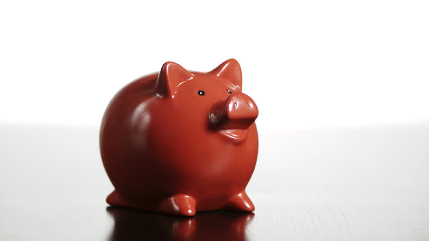 Studio shot of hammer breaking piggybank