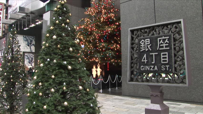 Tokyo, Japan - CIRCA November, 2006: Ginza Street sign with a Christmas tree in the background