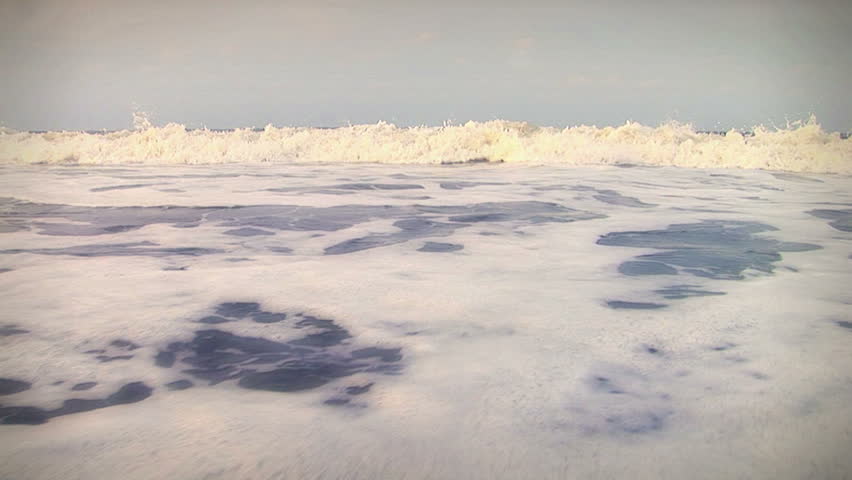 Great romantic / nostalgic beach surf shot. Good for themes of family, vacations, summer fun, travel, romance, beach-combing, contemplation, etc.