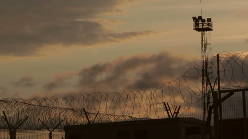 Barbed wire in the restricted area at sunset