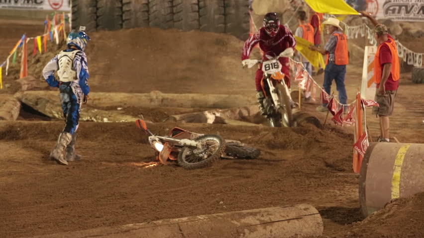 NEPHI, JUAB, UTAH 30 JUN 2012: Economic boost to rural community in annual race.  Motocross motorcycle race crash at obstacle. Juab County extreme enduro. Difficult course with jumps, logs and rocks.