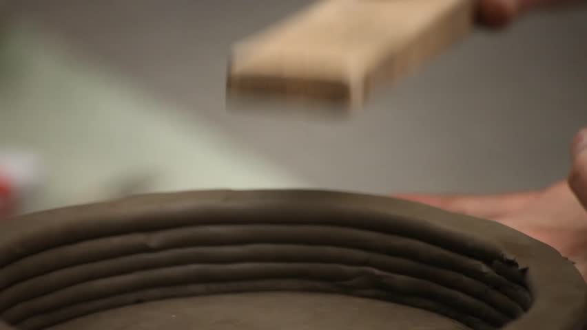 Pottery class workshop. Clay shaping on potter's wheel.
