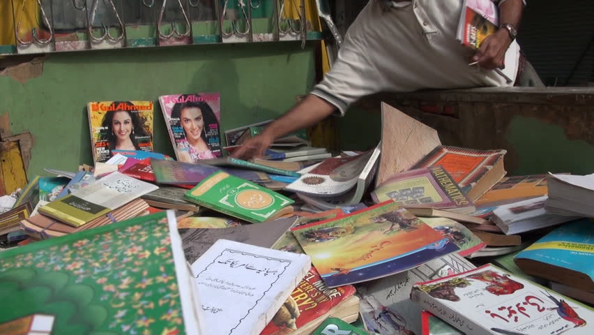 KARACHI - 23 OCTOBER 2010: A young man is searching for books and magazines in the back of a lorry in Karachi, Pakistan