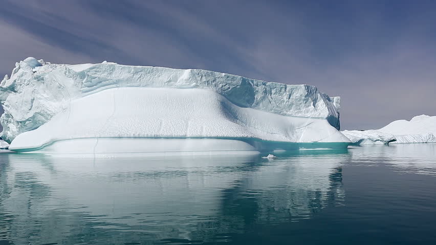 Drifting by an iceberg floating in Qooroq Icefjord, South Greenland