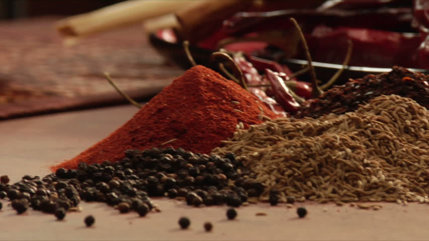 pan over mexican spices to reveal chili powder from a mocaljete
