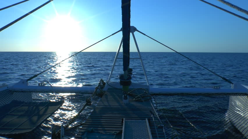 Catamaran, sailing to sunrise, Cuba