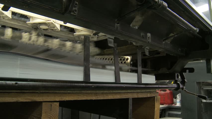 Printed sheets coming out of commercial printing press