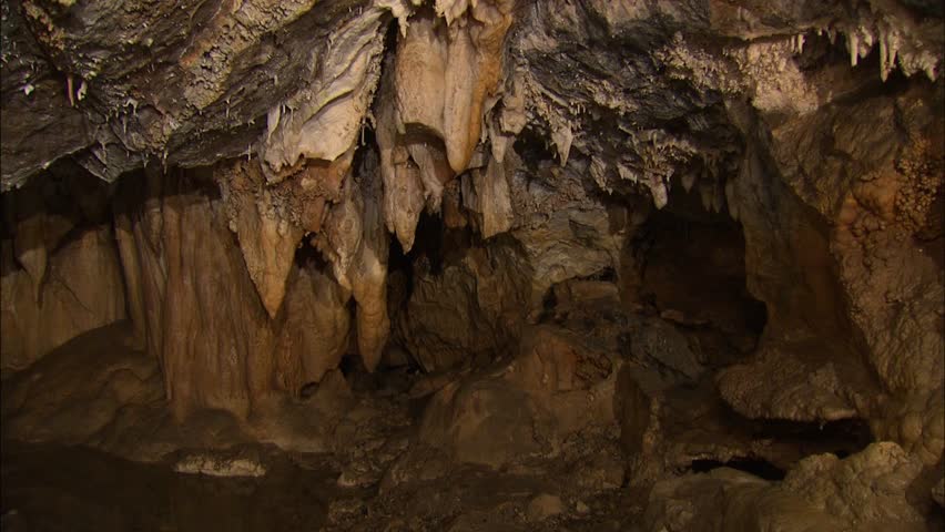 Cavern with stalactites and pool of water 