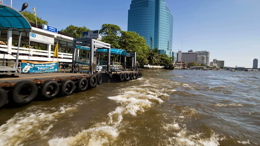 Time Lapse at speed along the Chao Phraya River passing Bangkoks Skyscrapers and Temples, Thailand, Asia
