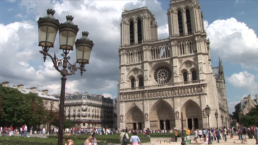 Paris, France - CIRCA June, 2006: Wide view of the Notre Dame Cathedral  with a large crowd out front as seen during the day