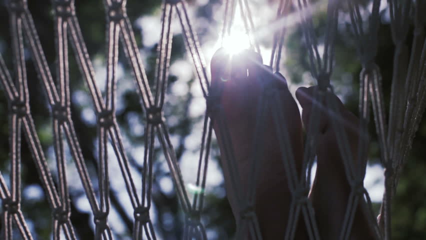 Legs in a hammock in the sunlight