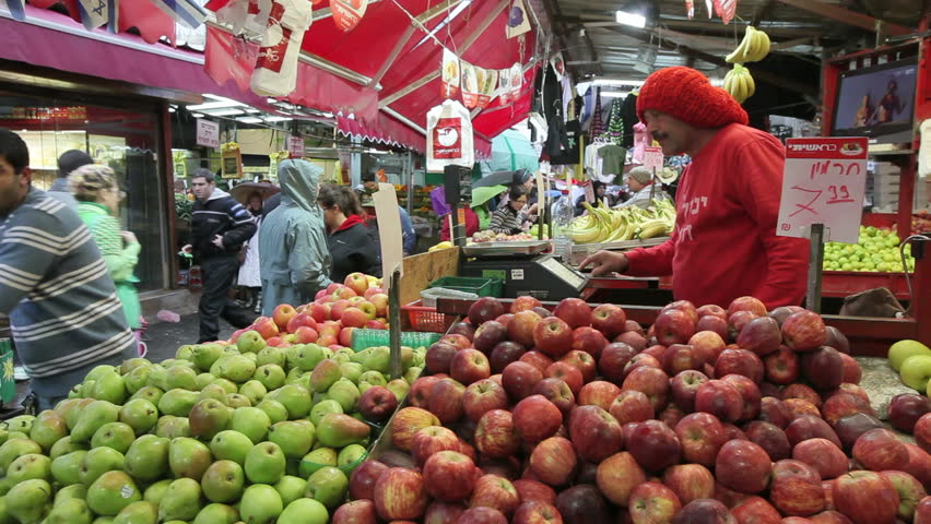 TEL AVIV, ISRAEL - CIRCA MAY 2011: Shuk HaCarmel market with a vendor selling goods