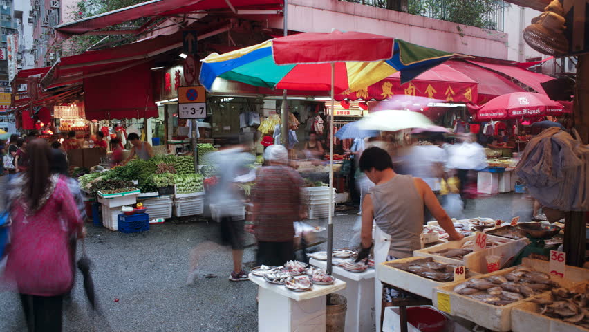 HONG KONG - CIRCA MAY 2011: Shoppers browse the traditional Chinese Stalls in Wanchai market