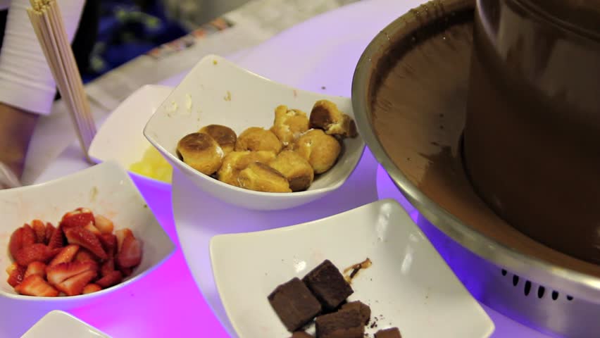 Dipping Skewer in Chocolate Fountain 2