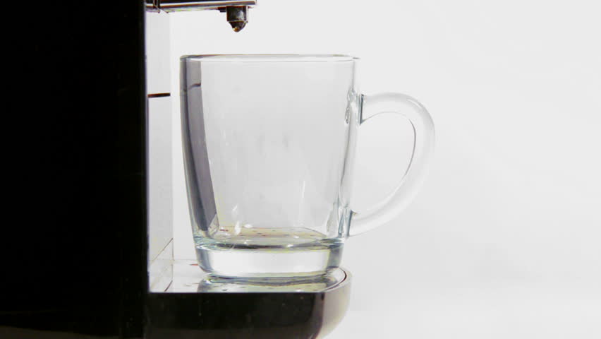 coffee maker pours coffee into a cup. close-up