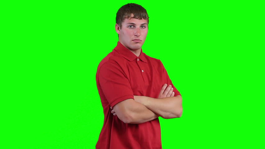 Male model looks at camera, smirks, turns and faces camera. With an attitude. Green screen/chromakey.