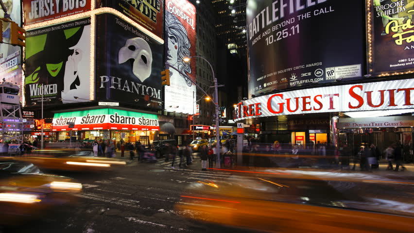 NEW YORK, NEW YORK - CIRCA MAY 2011: Wide angle view of people enjoying the neon lights of 42nd Street, Times Square, Manhattan